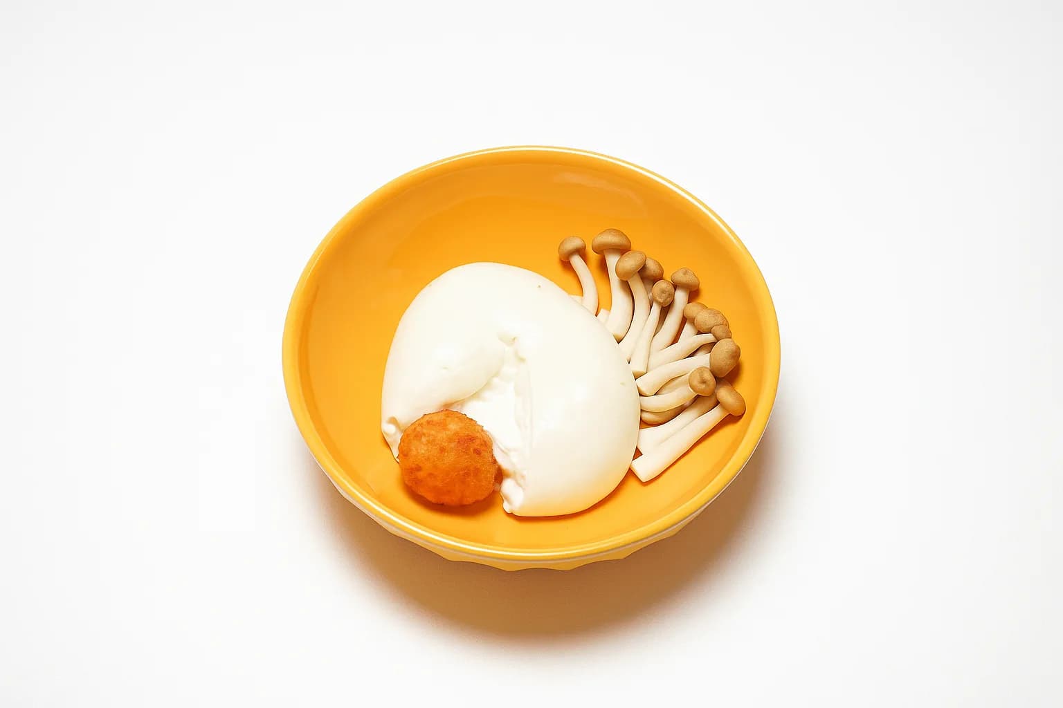 Croqueta con burrata y setas shimeji en cuenco amarillo